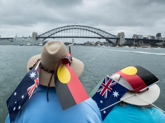 Participants wearing Australian and Aboriginal flags are seen aboard the ferry Emerald 6 during the annual Australia Day Ferrython on Sydney Harbour, Friday, January 26, 2018. (AAP Image/ Glenn Campbell) NO ARCHIVING