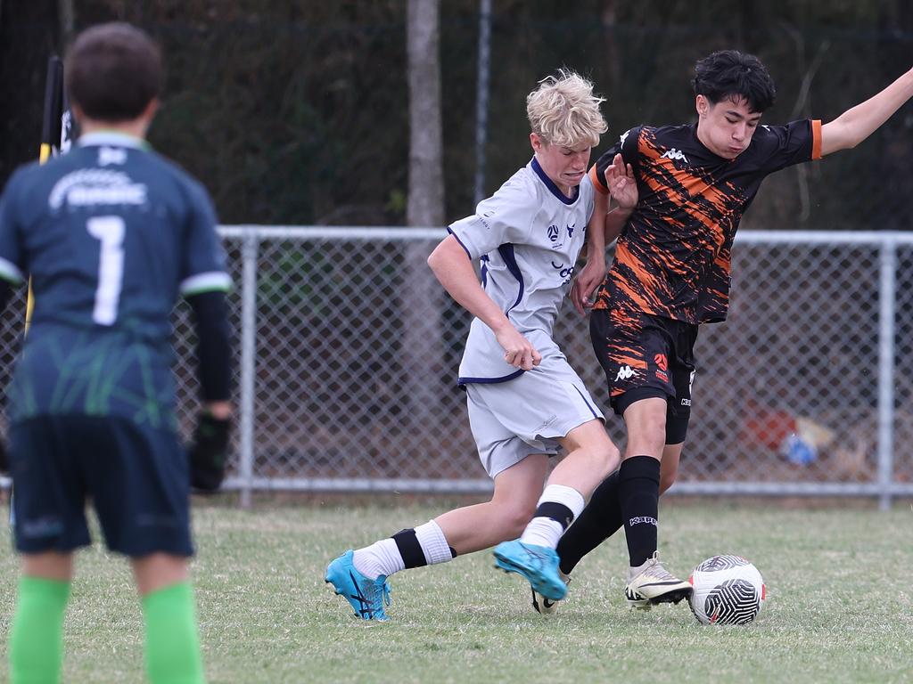 Premier Invitational Football 2024 tournament at Glennon Park Nerang. Field 2...Magic Utd (grey) V Football NT Utd. Picture Glenn Hampson