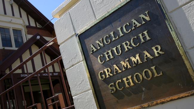 A former swim coach at Anglican Church Grammar School has been charged with sexual assault.