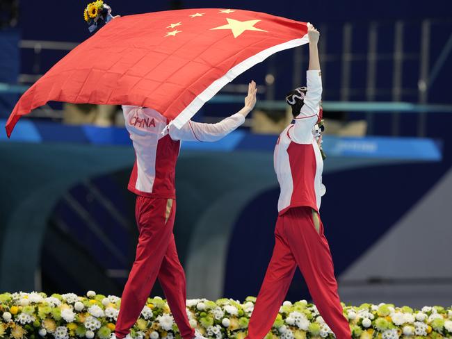 TOKYO, JAPAN - AUGUST 04: Silver medalists Huang Xuechen and Sun Wenyan of Team China celebrate with a Chinese national flag after the Artistic Swimming Duet Free Routine Final medal ceremony on day twelve of the Tokyo 2020 Olympic Games at Tokyo Aquatics Centre on August 4, 2021 in Tokyo, Japan. (Photo by Fred Lee/Getty Images)