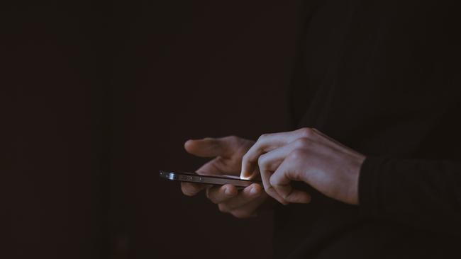 Generic image of man using mobile phone in the dark. Picture: Pixabay