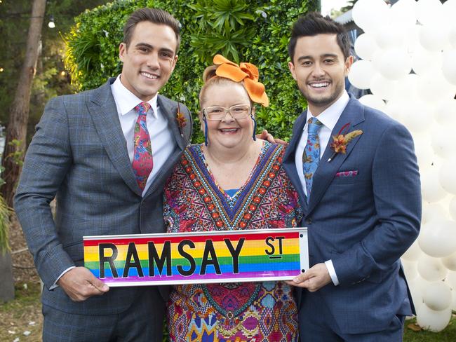 Takaya Honda’s David Tanaka and Matt Wilson’s Aaron Brennan, with Magda Szubanski playing wedding celebrant Jemima Davies-Smythe in the same-sex marriage episode of Neighbours.