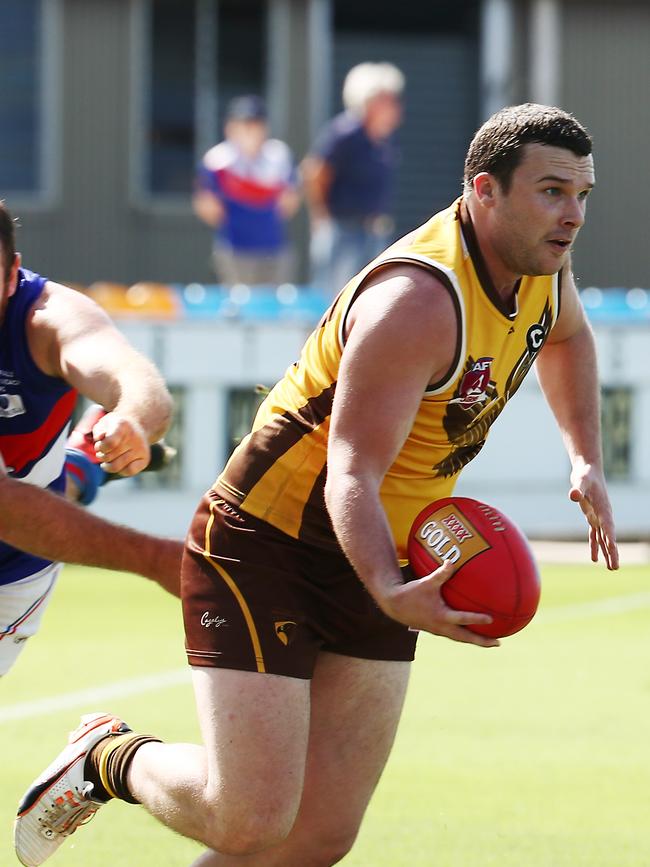 Hawks' Josh Coombs runs the ball right to the boundary in the AFL Cairns match between the Manunda Hawks and the Centrals Trinity Beach Bulldogs, held at Cazalys Stadium, Westcourt. PICTURE: BRENDAN RADKE