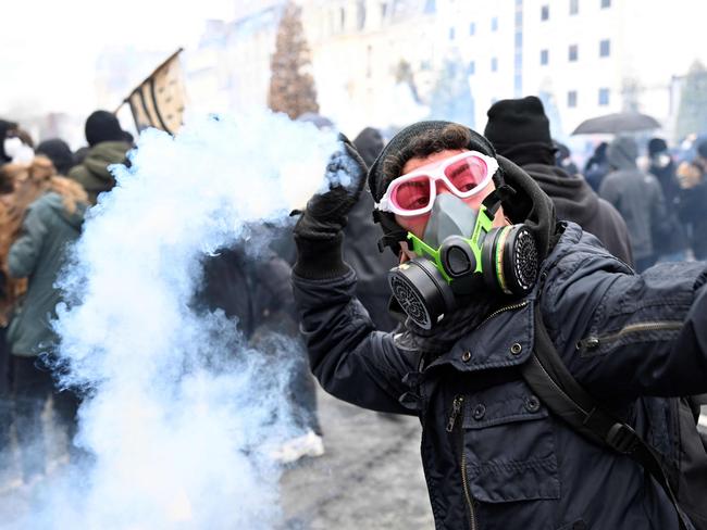 A demonstrator throws a tear gas grenade back at riot police during a rally in Rennes, western France. Picture: AFP