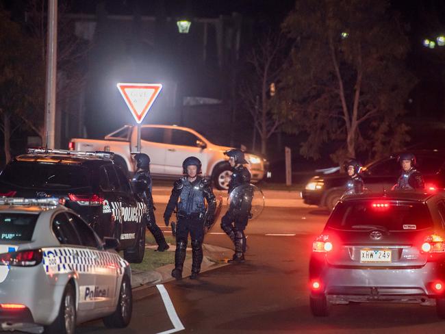 Police in riot gear in Taylors Hill. Picture: Jason Edwards