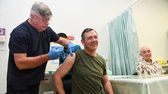 Chief Minister Michael Gunner receives his first dose of the COVID-19 vaccine from Dr Lionel Crompton in March 2021. Picture Katrina Bridgeford.