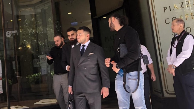 Richad Alameddine (front, wearing jeans) leaves court earlier this year over a separate matter alongside his solicitor Abdul Saddik (centre).