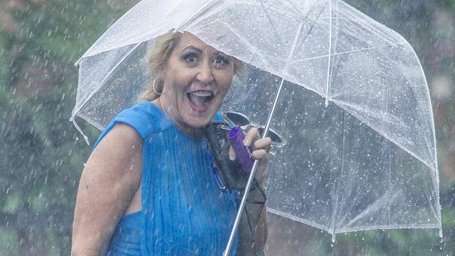 Umbrellas were a necessary part of all outfits as the Magic Millions race day was interrupted by heavy rain. Picture: Glenn Campbell