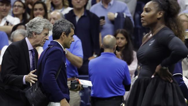 Carlos Ramos is escorted off the court at the completion of the women’s final.