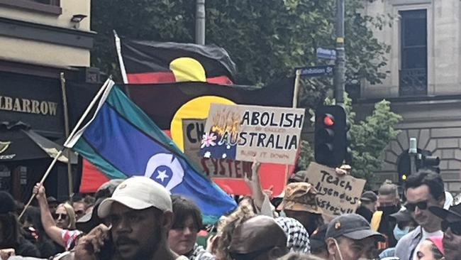 26-01-2024 - Attendees holding signs at an Invasion Day rally in Melbourne. Picture: Tricia Rivera