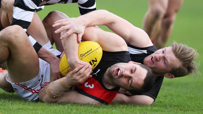 North Launceston playing-coach Taylor Whitford, front, comes in for some heavy attention from Glenorchy’s Callen Daly. Picture: NIKKI DAVIS-JONES