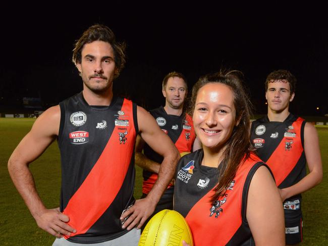 Troy Menzel, left, was playing for the Crows this time last year but now he's playing for Tea Tree Gully and coaching its under-18s, Thursday, May 24, 2018. Pictured with ex-AFL boundary umpire Jono Creasey, under 18 players Haley Pickering and Wil Cansdell. (AAP Image/ Brenton Edwards)