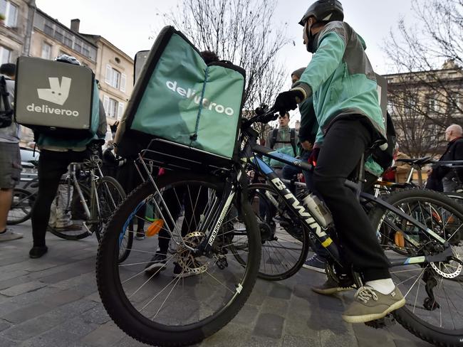 In this file photo taken on March 15, 2017, Deliveroo workers are pictured at a demonstration in Bordeaux in southwestern France. (Photo by GEORGES GOBET / AFP)