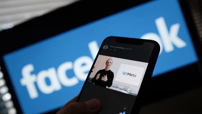 A smartphone shows Facebook’s Mark Zuckerberg unveiling the Meta logo in 2021. Picture: AFP