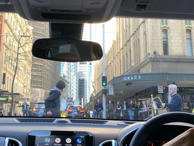 Another view from a driver inside their Mercedes Benz, where you can see the man wielding a knife on Clarence Street when he is confronted by a bystander with a chair trying to stop him. Picture: Twitter / @Ayusha77