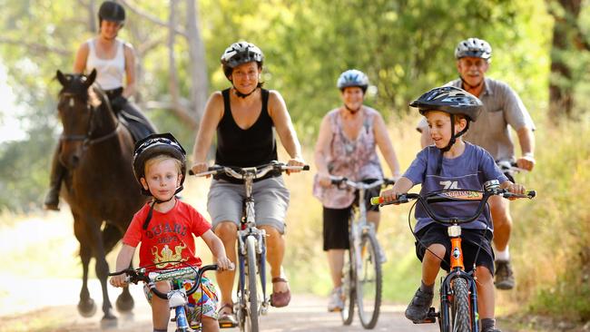 Owen, 4, Simone and Ethan, 6, lead Lauren Howes, 22, on Remi, and Diane and Mal Poulton on the Lilydale to Warburton Rail Trail, one of Victoria's many disused rail trails that have been turned into bicycle, walking and horseriding paths.