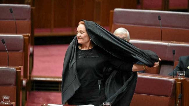 One Nation Senator Pauline Hanson takes off a burqa during Senate Question Time at Parliament House in Canberra, Thursday, August 17, 2017. Picture: LUKAS COCH