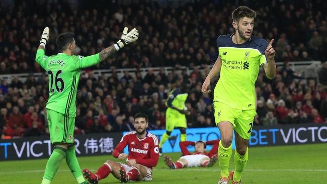 Liverpool's English midfielder Adam Lallana (R) celebrates scoring.