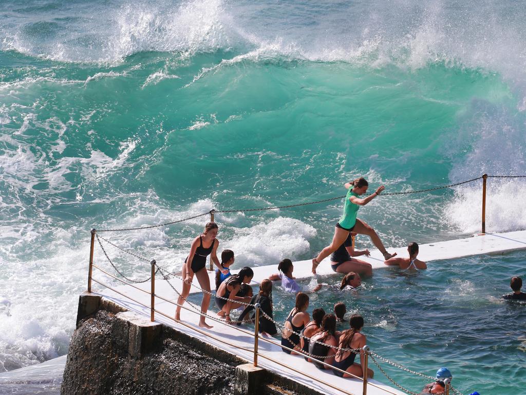 Swimmers at Bondi Icebergs are battered by large swell. Picture: Cameron Richardson
