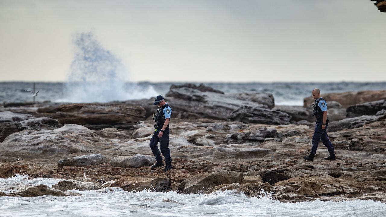 Police officers returned to Little Bay at dawn. Picture: Julian Andrews