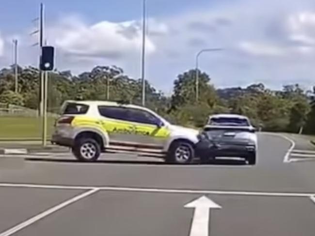 Dash cam footage shows the moment an ambulance with its lights on collides with another car on a busy intersection. Picture: Dash Cam Owners Australia