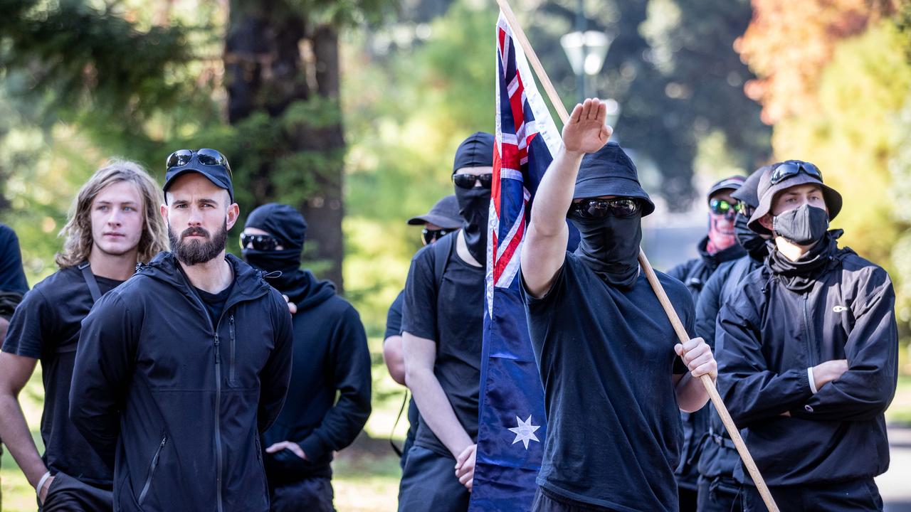 NSN leader Thomas Sewell stands by while a member displays the Hitler salute. members of the Melbourne based group have been active in Geelong. Picture: Jake Nowakowski