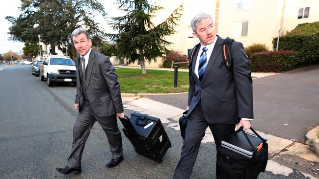 Federal police officers raiding the home of News Corp Australia journalist Annika Smethurst on Tuesday.