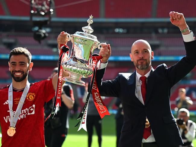 LONDON, ENGLAND - MAY 25: Bruno Fernandes of Manchester United and Erik ten Hag, Manager of Manchester United, celebrate with the Emirates FA Cup Trophy after their team's victory in the Emirates FA Cup Final match between Manchester City and Manchester United at Wembley Stadium on May 25, 2024 in London, England. (Photo by Mike Hewitt/Getty Images)