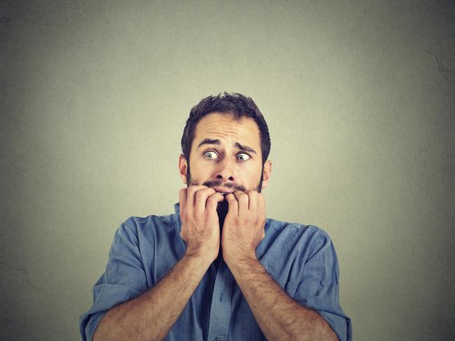 Portrait anxious young man biting his nails fingers freaking out, frightened, generic, scared