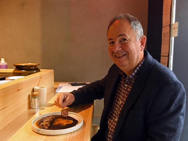 Advertiser food editor Simon Wilkinson samples the wagyu beef skewers at Shobosho. Picture: Tom Huntley