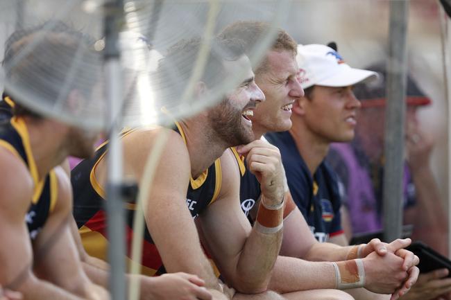 Adelaide’s Andy Otten sees the funny side of the heat while sitting on the Crows bench with Reilly O’Brien at Port Pirie. Picture SARAH REED