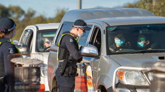 People travelling from NSW into Victoria on the Hume Freeway near Wodonga are stopped by Vic police. Picture: NCA NewsWire/Simon Dallinger