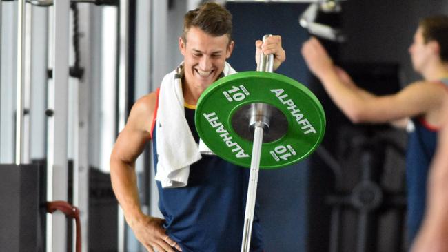 Tom Doedee lifting weights at training.