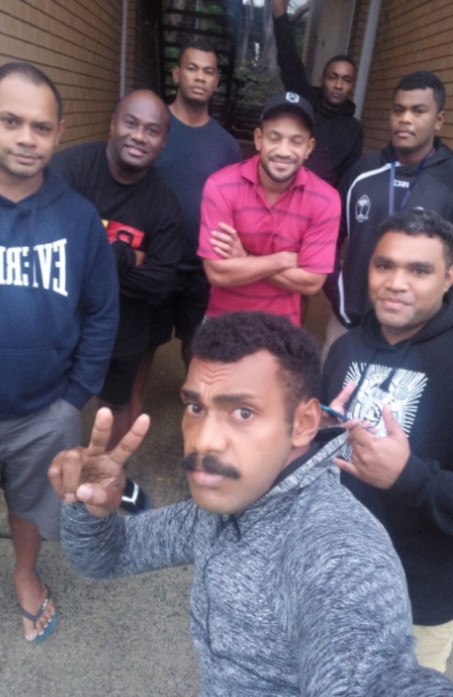 Apenisa Marau (black hoodie with white printed design) and his Fijian mates are lending a hand in Lismore.