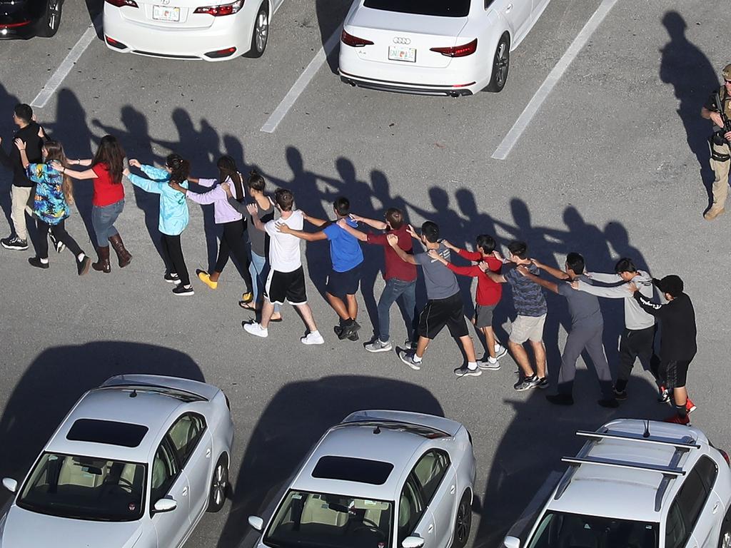 People are brought out of the Marjory Stoneman Douglas High School after a shooting at the school. Picture: Getty Images