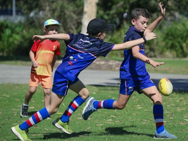 Kids kick a footy before the Gold Coast Swans take on the Sydney Swans at People First Stadium, Carrara. Picture: Glen Campbell