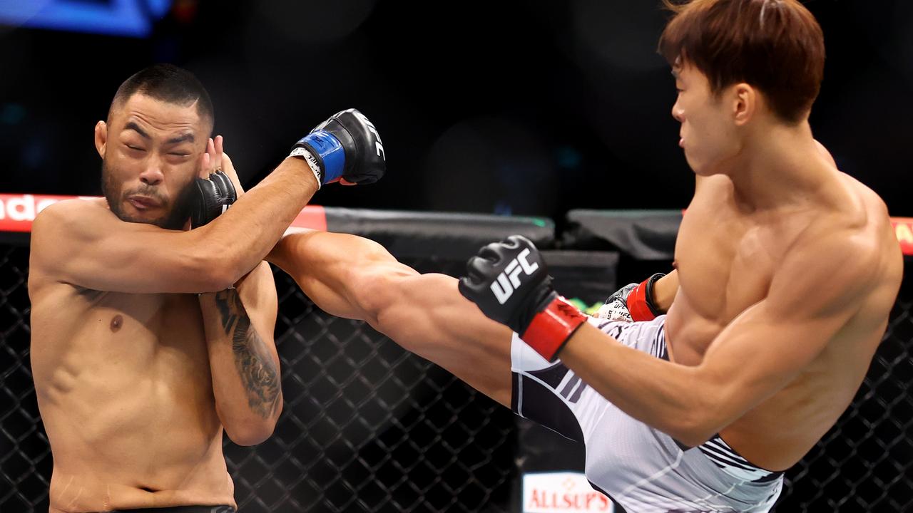 SINGAPORE, SINGAPORE - JUNE 12: Seungwoo Choi (R) of South Korea kicks Josh Culibao of Australia in their featherweight bout during UFC 275 at Singapore Indoor Stadium on June 12, 2022 in Singapore. (Photo by Yong Teck Lim/Getty Images)