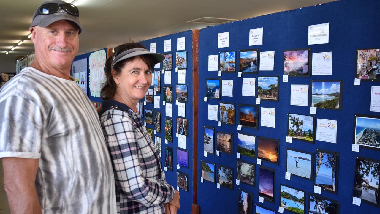 Gary and Corrina O'Brien of Airlie Beach checking out the photography display in the arts and crafts pavilion. Picture: Kirra Grimes