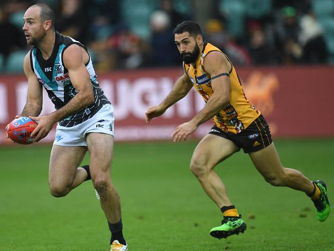 Matthew Broadbent of the Power (left) and Paul Puopolo of the Hawks contest during the Round 10 AFL match between the the Hawthorn Hawks and Port Adelaide Power at the University of Tasmania Stadium in Launceston, Saturday, May 25, 2019. (AAP Image/Julian Smith) NO ARCHIVING, EDITORIAL USE ONLY