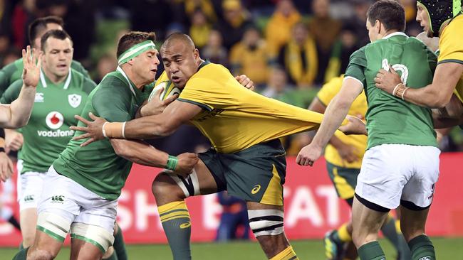 Caleb Timy on the charge during a mixed game for the Wallabies. Picture: AFP PHOTO / WILLIAM WEST