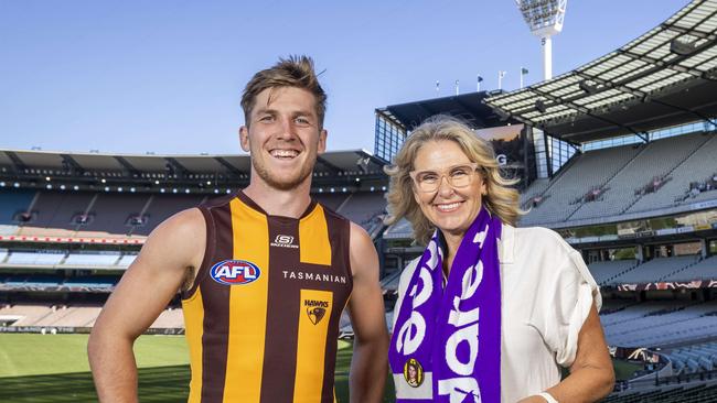 Hawthorn player Dylan Moore at the MCG who wears the number 13 which is Paul Dear's former jumper. The game will raise funds for pancreatic cancer research. Pictured with Paul Dears wife Cherie.Picture by Wayne Taylor 27th March 2024