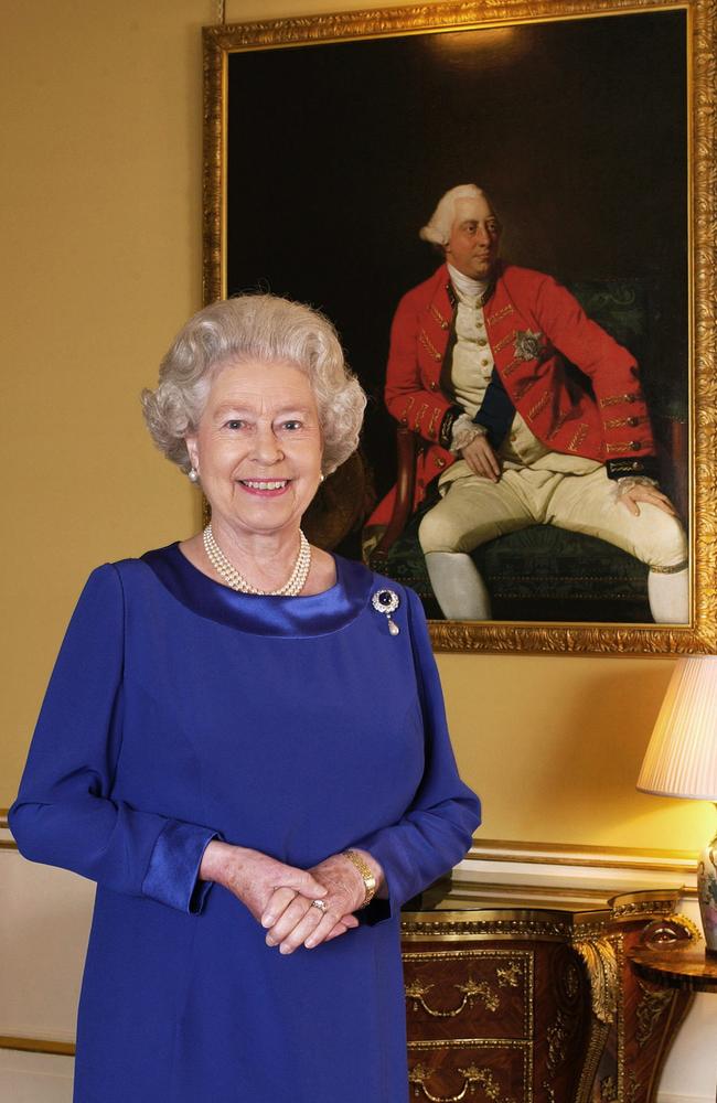 October 25, 2001: Queen Elizabeth II stands in the 18th Century Room at London's Buckingham Palace. A 1771 Johann Zoffany portrait of King George III hangs in the background.