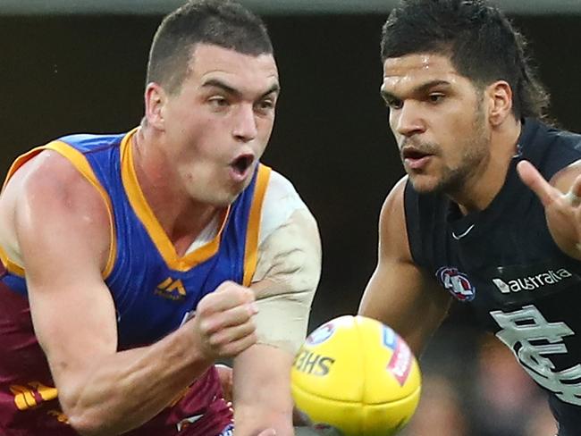 BRISBANE, AUSTRALIA - JULY 23:  Tom Rockliff of the Lions handballs during the round 18 AFL match between the Brisbane Lions and the Carlton Blues at The Gabba on July 23, 2017 in Brisbane, Australia.  (Photo by Chris Hyde/Getty Images)