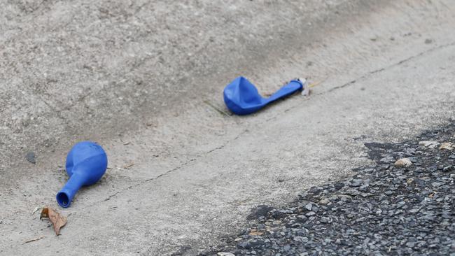 Balloons allegedly used for inhaling substances littered the road. Picture: Brendan Radke