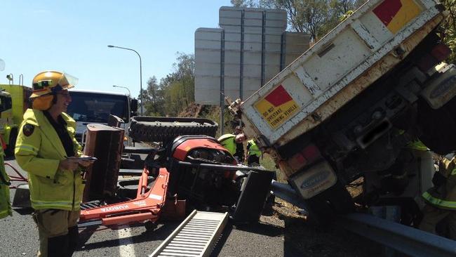 Bobcat trailer crashes and flips on M1 | news.com.au — Australia’s ...