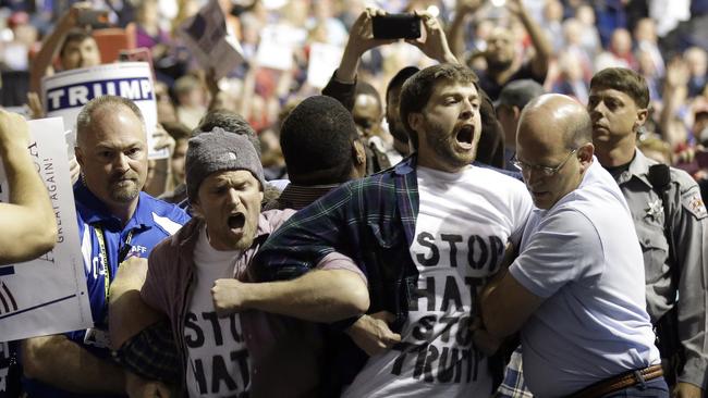 Protesters are removed from a Trump rally. Picture: Gerry Broome