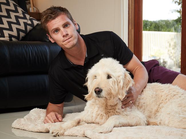 Aaron O'Toole poses for a picture with his parent's dog Stan, 9. Picture: AAP/Matt Loxton