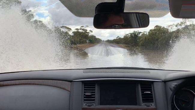 Paul Ashenden drives through flooded roads near Darke Peak on the Balumbah-Kinnard Rd after being detoured due to the main Highways being closed. Picture: Paul Ashenden