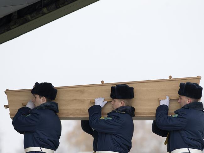 The remains of MH17 victims are loaded onto a plane during a ceremony at Kharkiv airport, as the foreign minister shares doubts about the rest of the recovery mission.