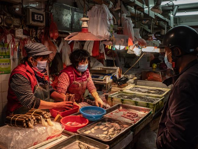 Residents purchasing seafood at a wet market in January in Macau, China. Picture: Anthony Kwan/Getty